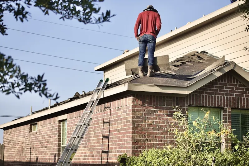 Professional roofer working on a residential roof in Landisville